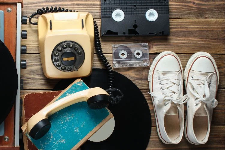 Des objets des années 70 et 80 comme une cassette, un vinyle et un téléphone fixe à touche.